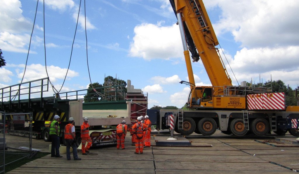 crane lifting large load supported by heavy duty crane mats