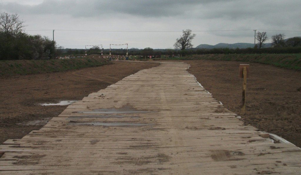 temporary roadway over muddy ground at work site