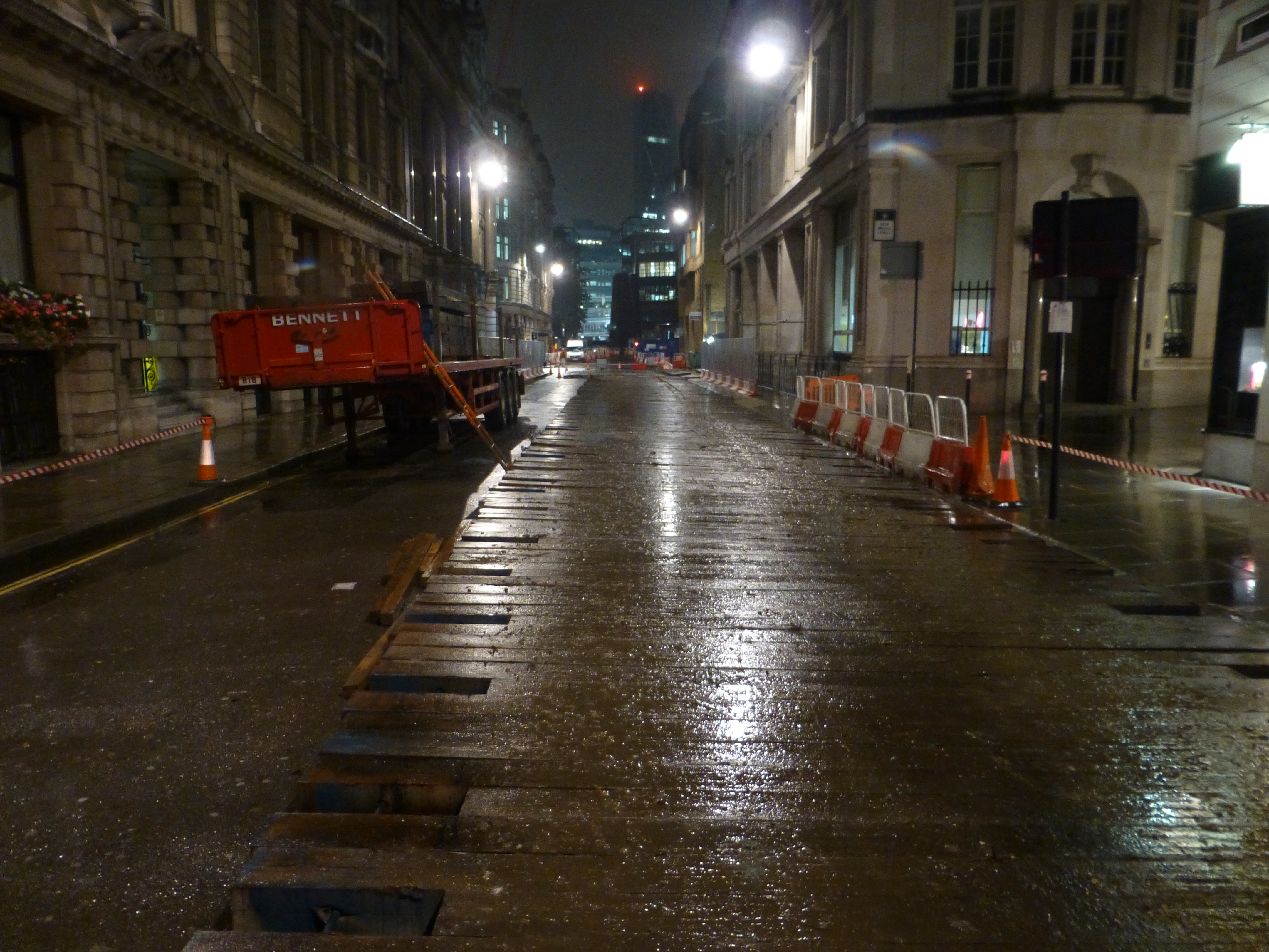 oak bog mats on wet street at night in the city centre