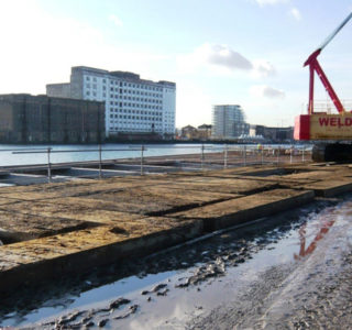 Temporary road for heavy machinery over wet ground by a the docks